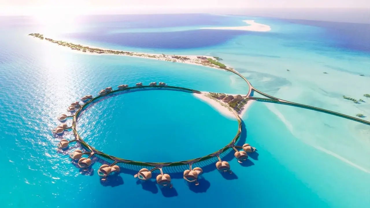 Resort circolare su palafitte nel Mar Rosso Arabia Saudita, con isole sabbiose e acque turchesi.