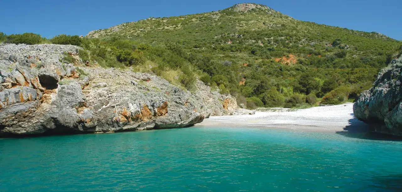 Acque cristalline e una spiaggia appartata, perfette per vacanze al mare economiche e rigeneranti.